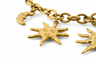 Trendy gold-plated stainless-steel charm necklace on a white background