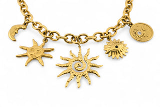 Trendy gold-plated stainless-steel charm necklace on a white background