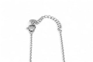 Close up photo of the closure of a silver necklace