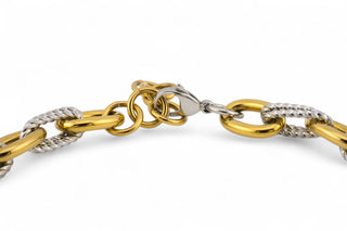 Gold and silver chain necklace closure on a white background