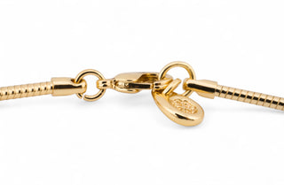 18k gold plated pendant necklace with a large round pendant on a white background