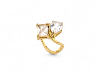 Gold plated ring with two clear gemstones zirconias on a white background