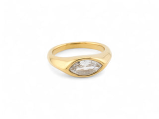 Gold trendy ring with a clear gemstone zirconia on a white background