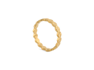 Gold ring with textured design on a white background