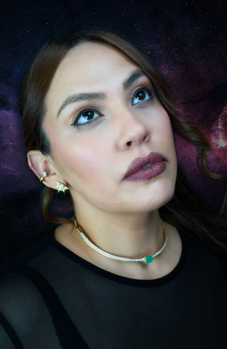 Woman wearing gold plated star shaped earrings and a gold plated zirconia choker necklace