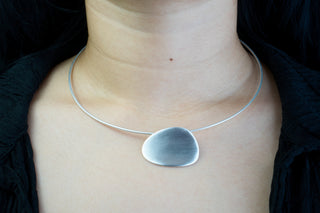 Woman wearing rhodium plated pendant necklace 