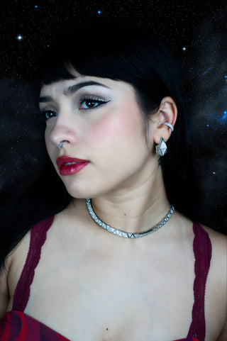 Woman wearing set of necklace, earring and ear cuff with rhodium plated and zirconias