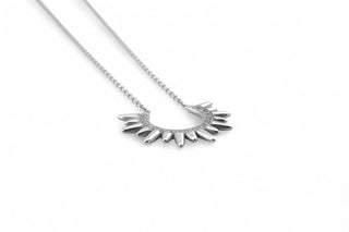 Silver necklace with a unique pendant on a white background