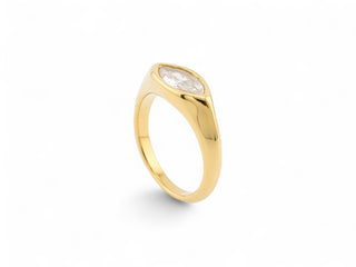 Gold ring with a white gemstone zirconia on a white background