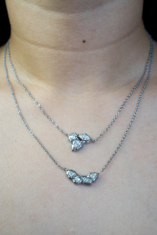 Two layered stainless steel silver zirconia necklaces on a woman's neck 