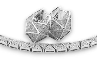 Silver necklace with geometric design with geometric silver earrings with zirconis on a white background